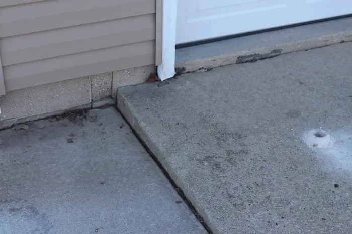 Driveway apron raised to close the garage-door gap after polyfoam concrete leveling
