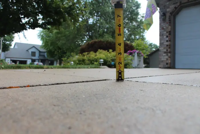 Yardstick at the driveway seam after the slabs were realigned with polyfoam concrete leveling