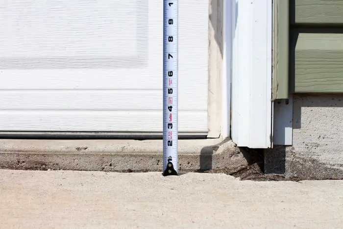 Slab raised back to the garage door threshold after polyfoam concrete leveling