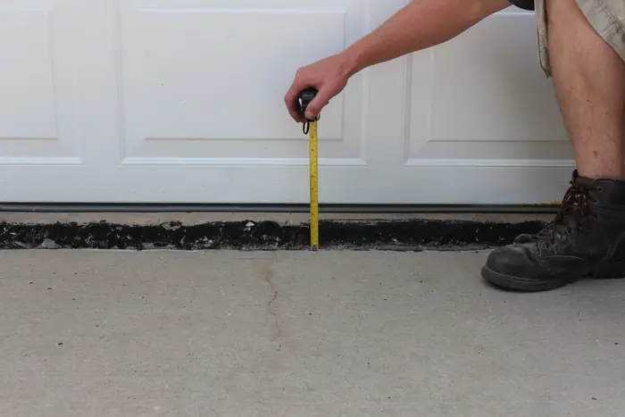 Garage door apron raised and the gap sealed after polyfoam concrete leveling