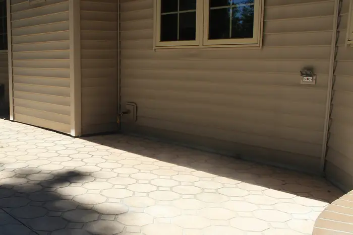 Paver patio raised level against the house after polyfoam concrete leveling