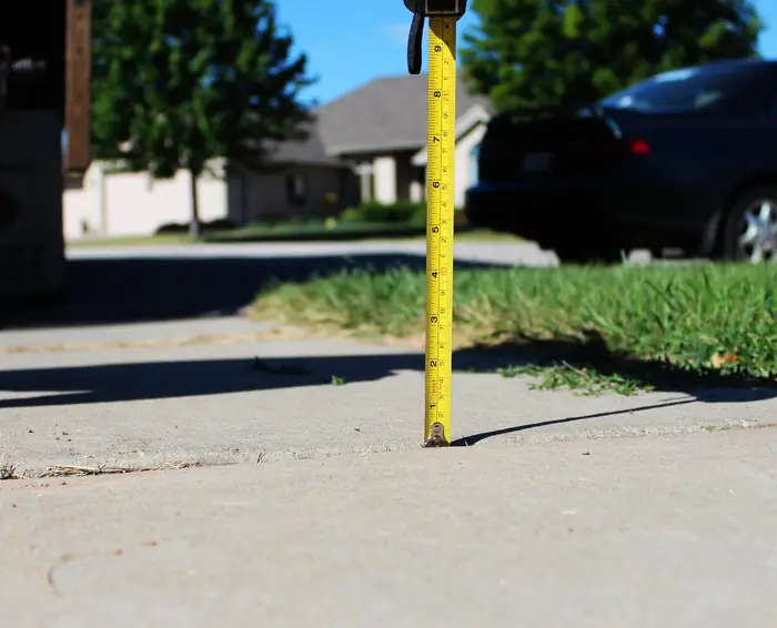 Sidewalk seam raised smooth and flush after polyfoam concrete leveling
