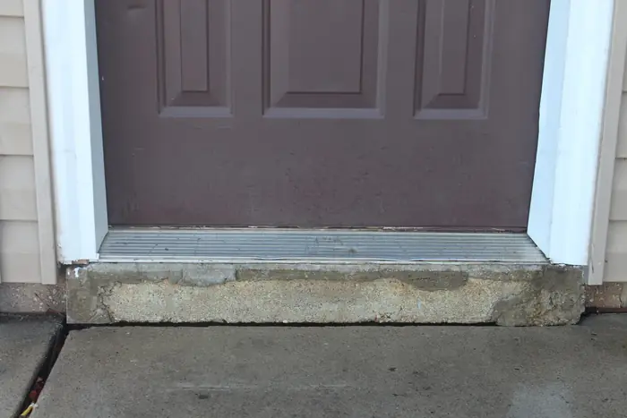 Front concrete step raised back to the door threshold after polyfoam concrete leveling