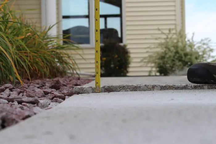 Front walkway slab dropped below the neighboring section before polyurethane foam lifting